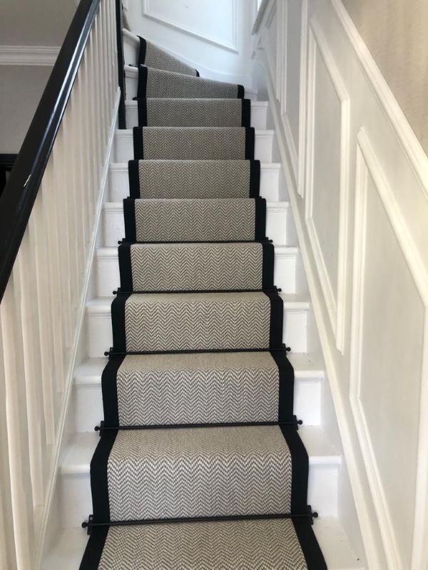 Close-up of Fibre Flatweave Classic Dapple carpet stair runner with black edging and Stair Rods in Chingford E4